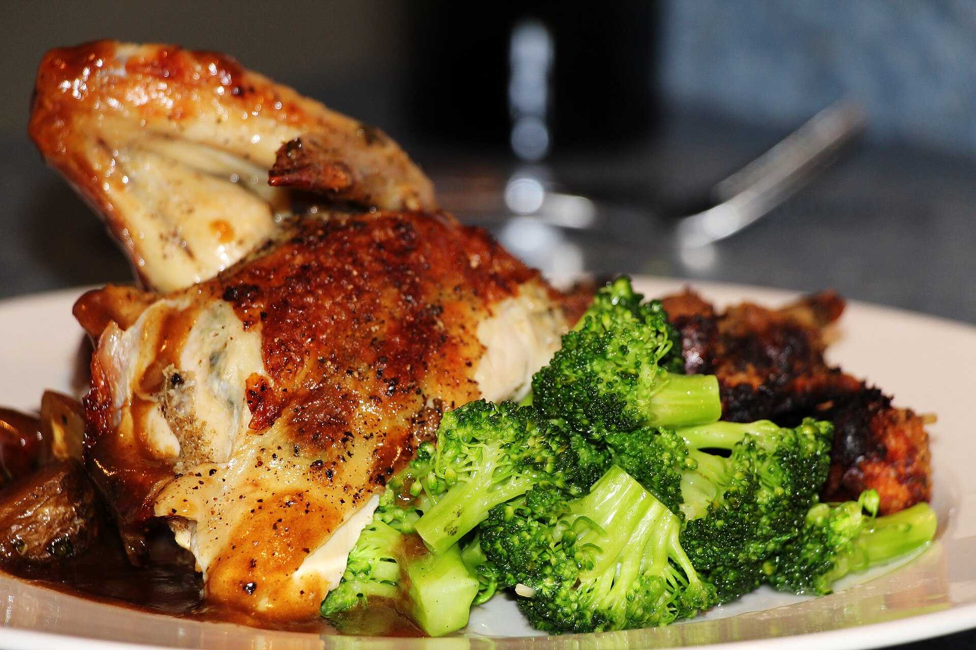 A roast chicken dinner with broccoli