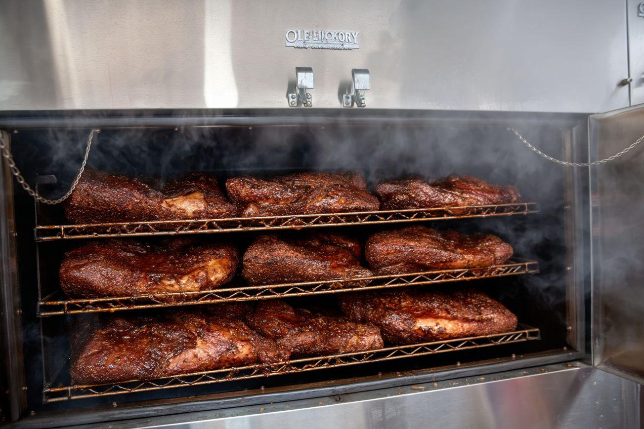 Whole briskets on the smoker at 322 BBQ